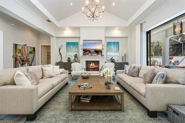 a living room with furniture fireplace and a large window
