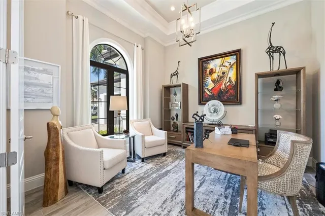 a living room with fireplace furniture and a large window