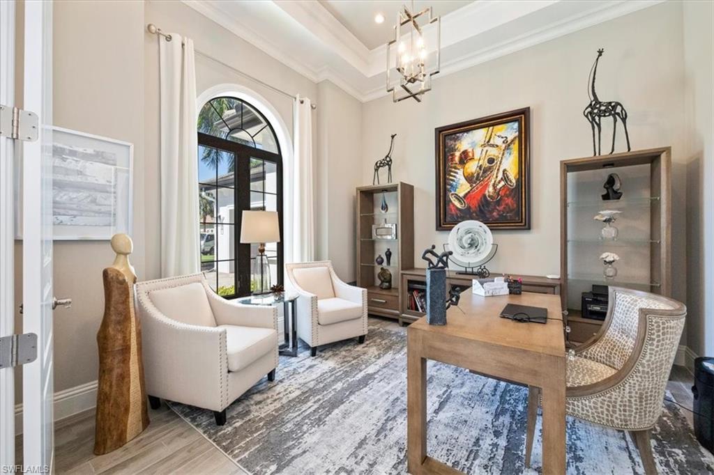 6363 Burnham Road Naples, FL 34119 - Photo 10 of 38 a living room with fireplace furniture and a large window