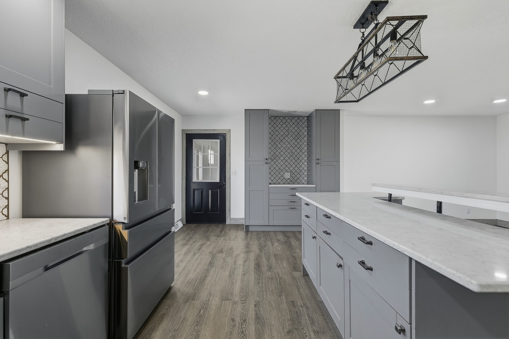 11622 27th Street West Milan, IL 61264 - Photo 7 of 49 a kitchen with white cabinets and stainless steel appliances