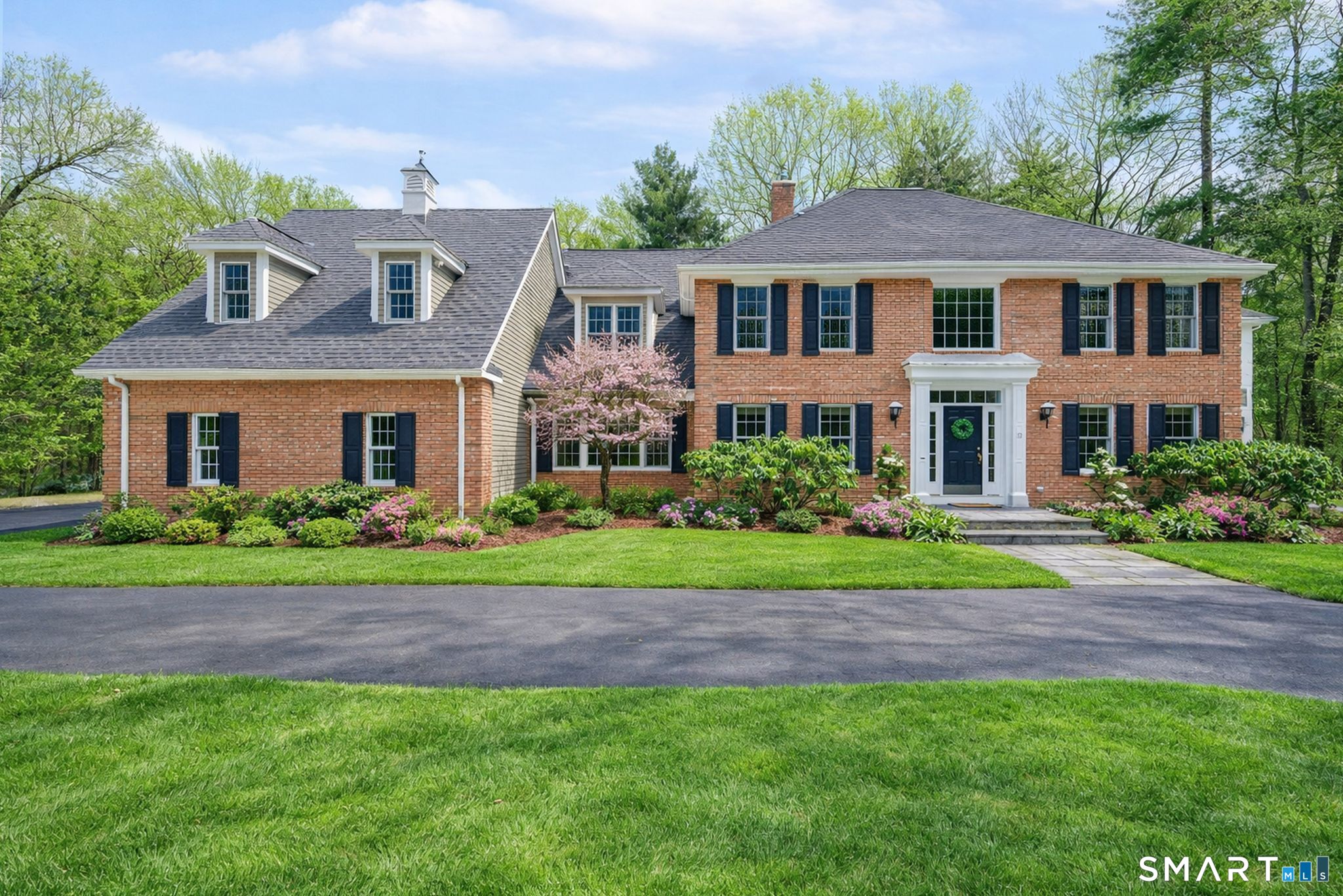 12 The Glade Simsbury, CT 06070 - Photo 1 of 1 a front view of a house with a garden