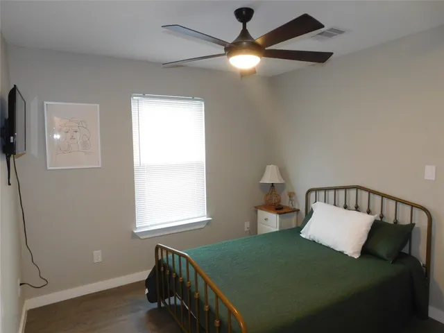 a bedroom with a bed and window