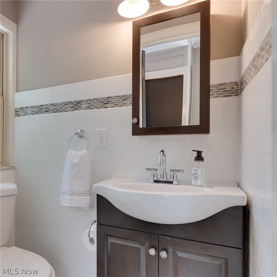 1046 Allston Road Cleveland Heights, OH 44121 - Photo 17 of 34 Main floor half bath. Classic subway tile with the chic of the matching glass mosaic tile form the kitchen.