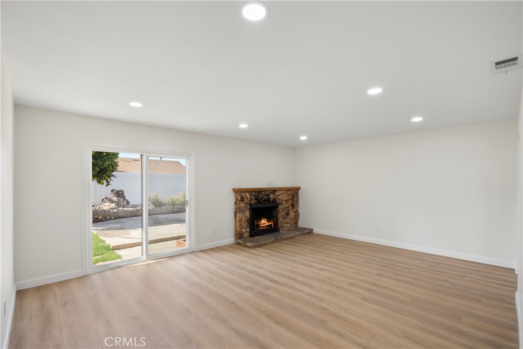 3670 Upper Terrace Drive Riverside, CA 92505 - Photo 4 of 30 an empty room with wooden floor fireplace and windows