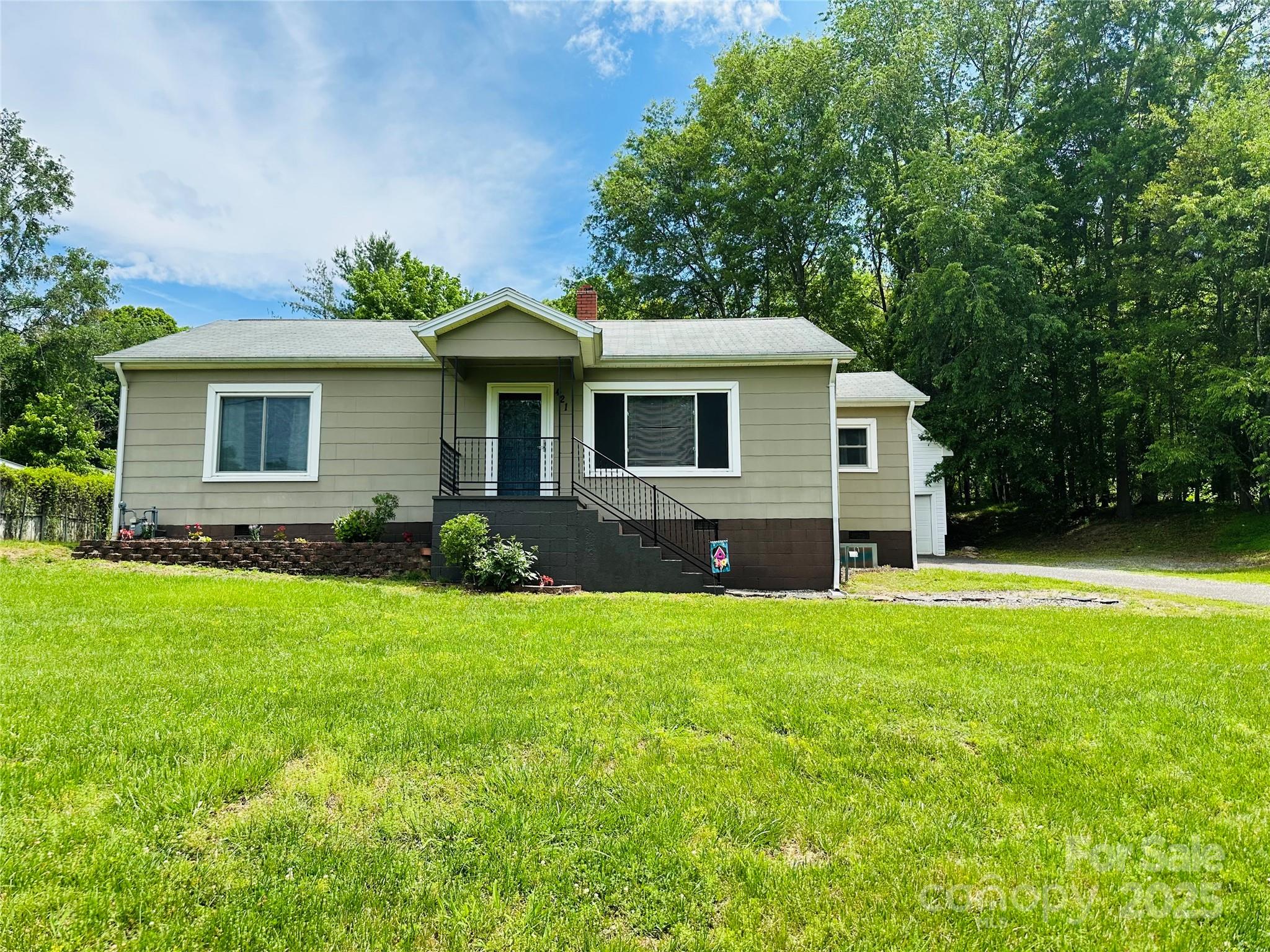 a front view of house with yard and green space