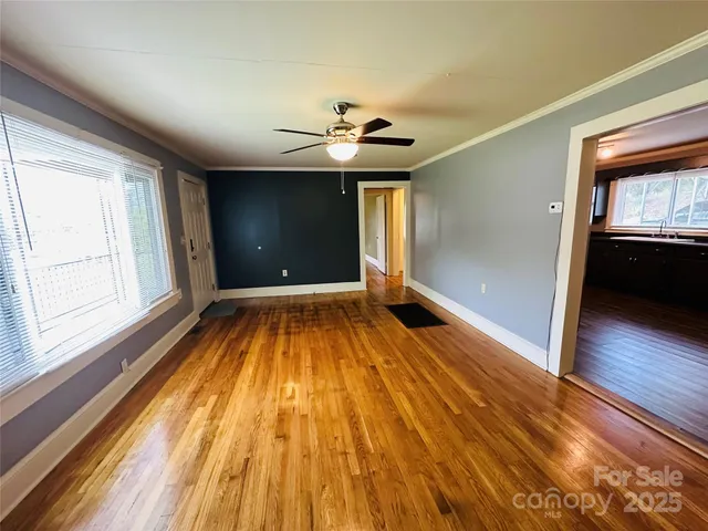 a view of empty room with wooden floor