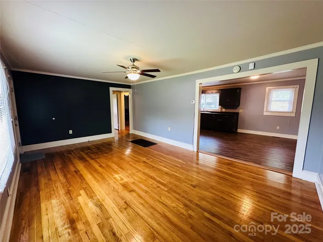 a view of empty room with wooden floor