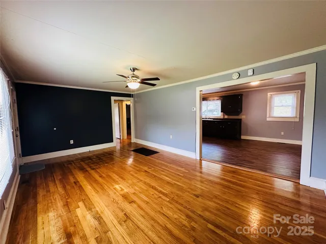 a kitchen with stainless steel appliances granite countertop a refrigerator oven a sink dishwasher and wooden cabinets with wooden floor