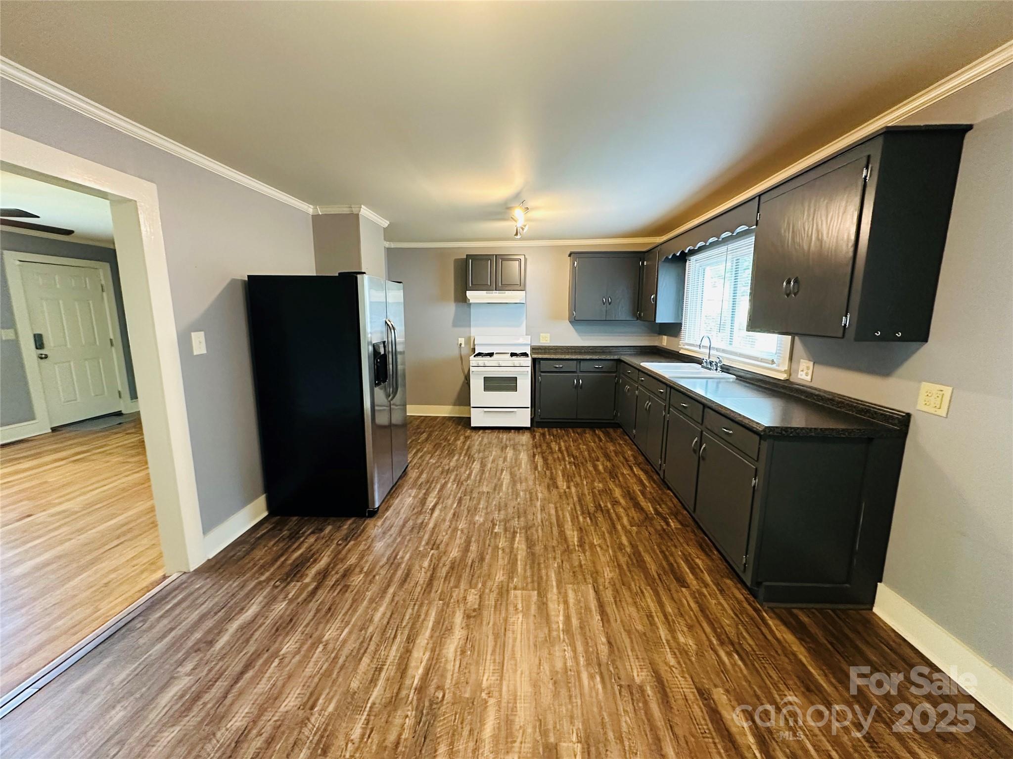 421 Bethel Road Morganton, NC 28655 - Photo 26 of 40 a kitchen with stainless steel appliances granite countertop a refrigerator oven a sink dishwasher and wooden cabinets with wooden floor