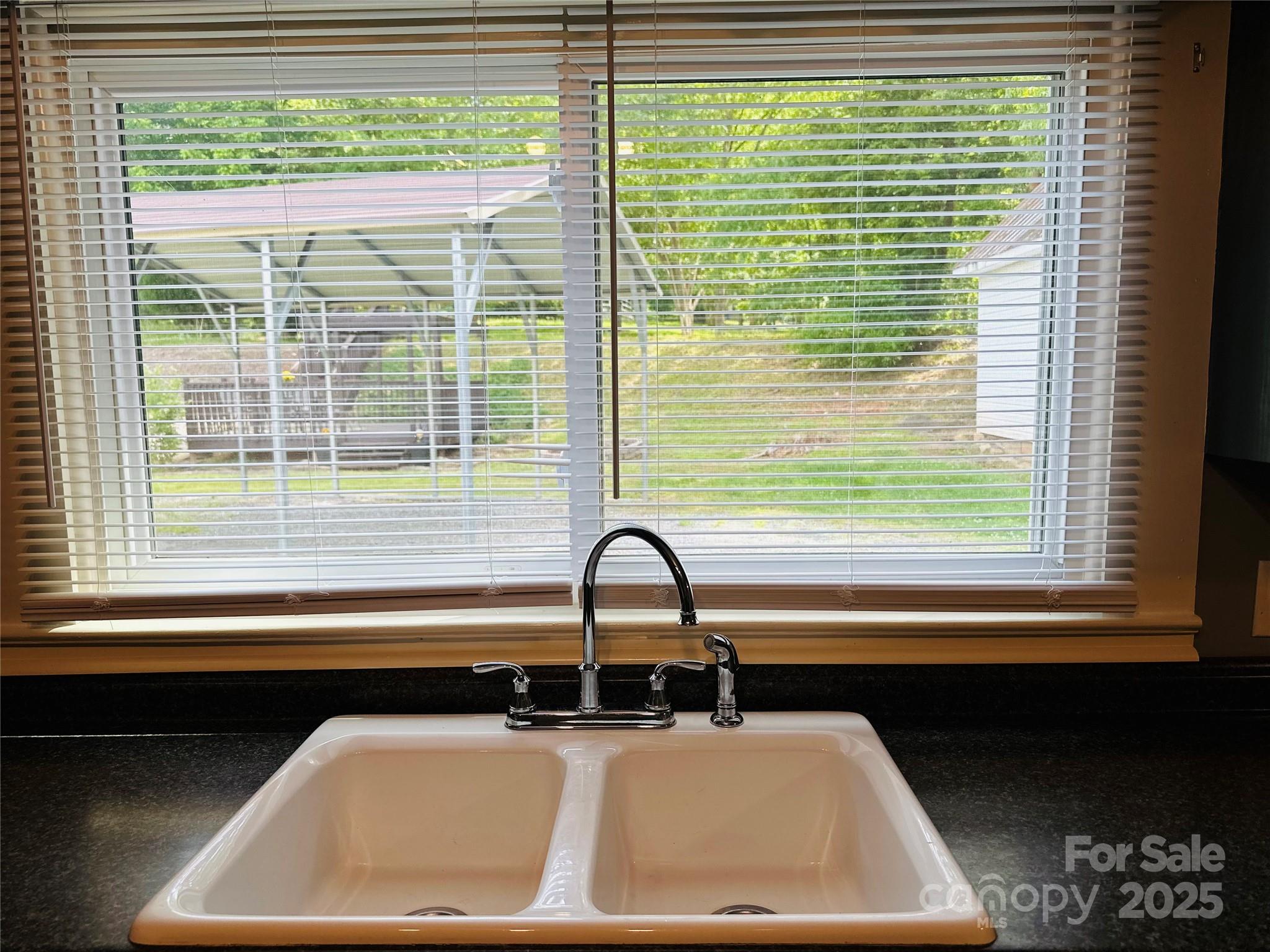 421 Bethel Road Morganton, NC 28655 - Photo 27 of 40 a bathroom with a sink a window and a window