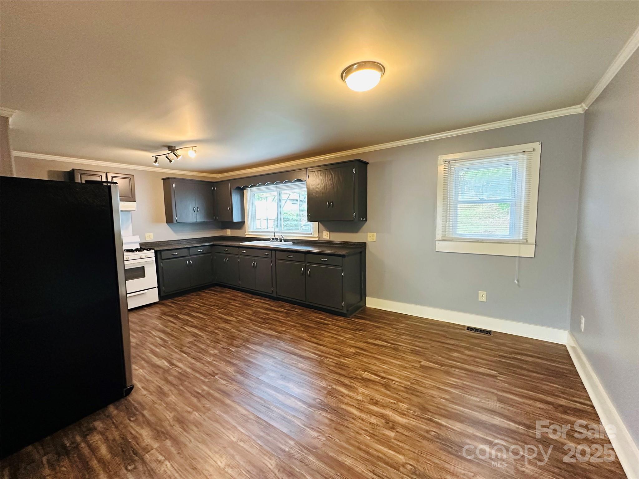 421 Bethel Road Morganton, NC 28655 - Photo 29 of 40 a kitchen with granite countertop a refrigerator and a sink
