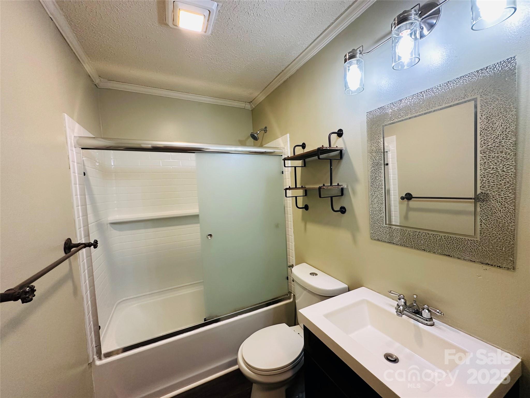421 Bethel Road Morganton, NC 28655 - Photo 38 of 40 a bathroom with a sink mirror toilet and shower