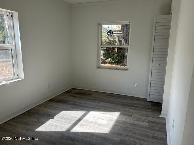 9727 Tiffany Avenue Jacksonville, FL 32246 - Photo 13 of 19 an empty room with wooden floor and windows