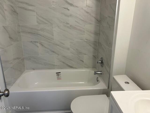 9727 Tiffany Avenue Jacksonville, FL 32246 - Photo 16 of 19 a bathroom with a toilet and bathtub