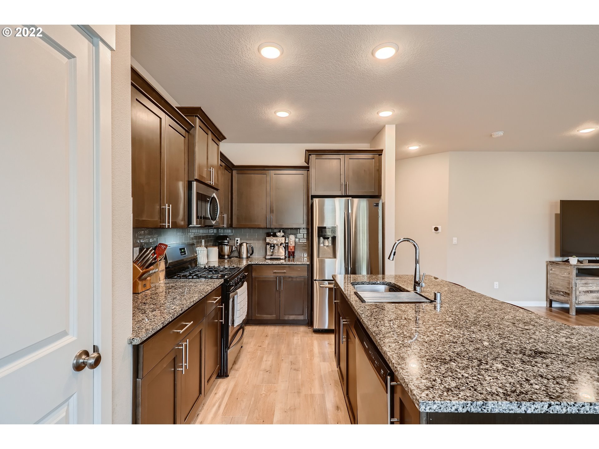 1416 Northeast 172nd Street Ridgefield, WA 98642 - Photo 12 of 28 a kitchen with sink refrigerator and cabinets