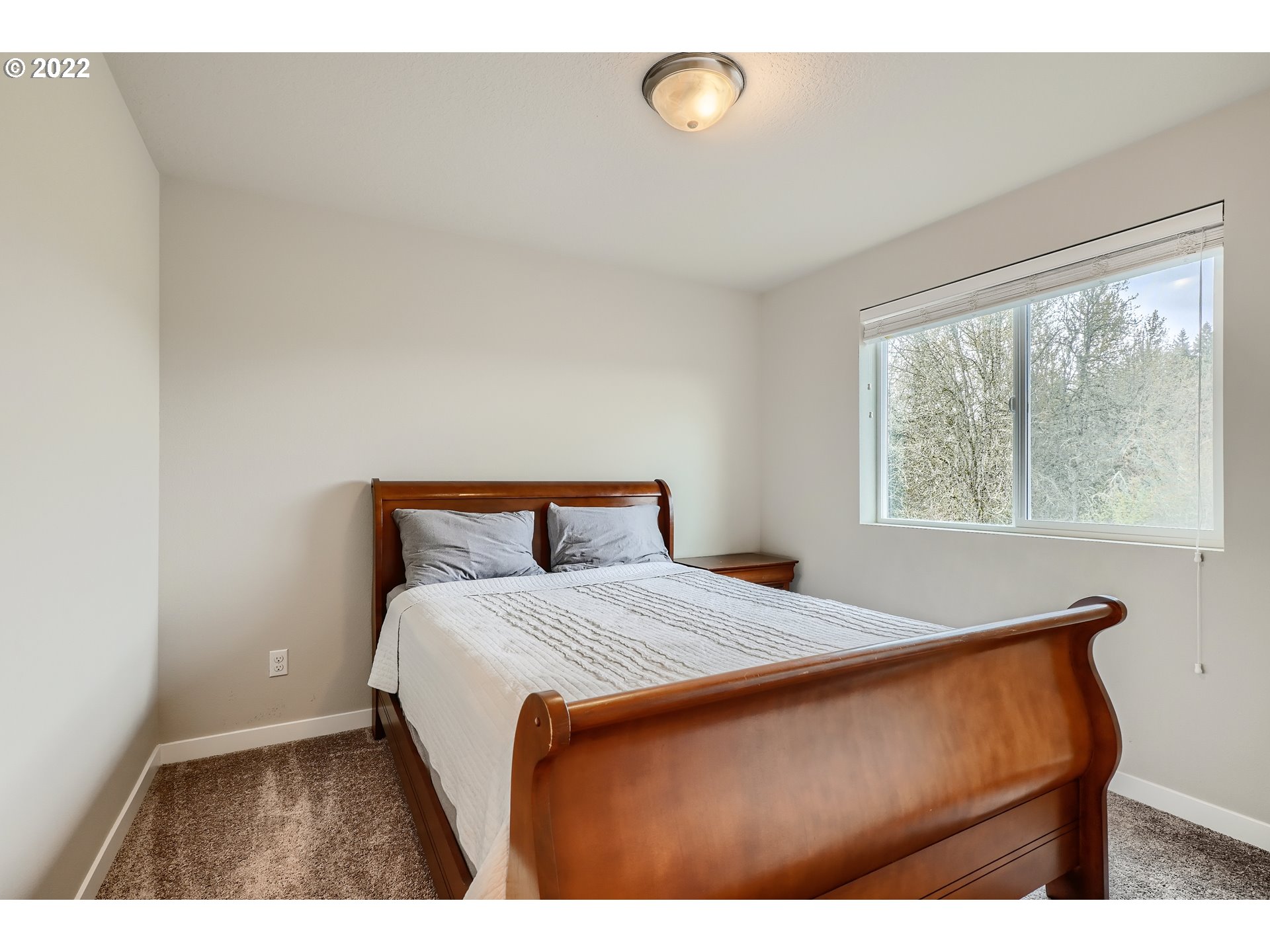 1416 Northeast 172nd Street Ridgefield, WA 98642 - Photo 23 of 28 a bed sitting in a bedroom next to a window