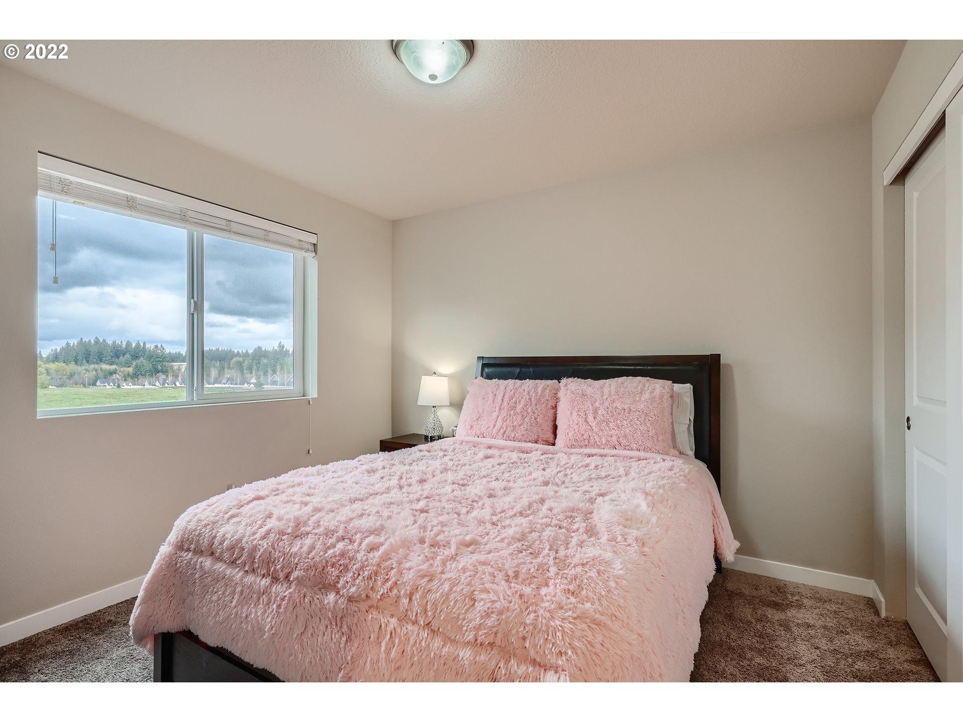 1416 Northeast 172nd Street Ridgefield, WA 98642 - Photo 24 of 28 a bedroom with a bed and window