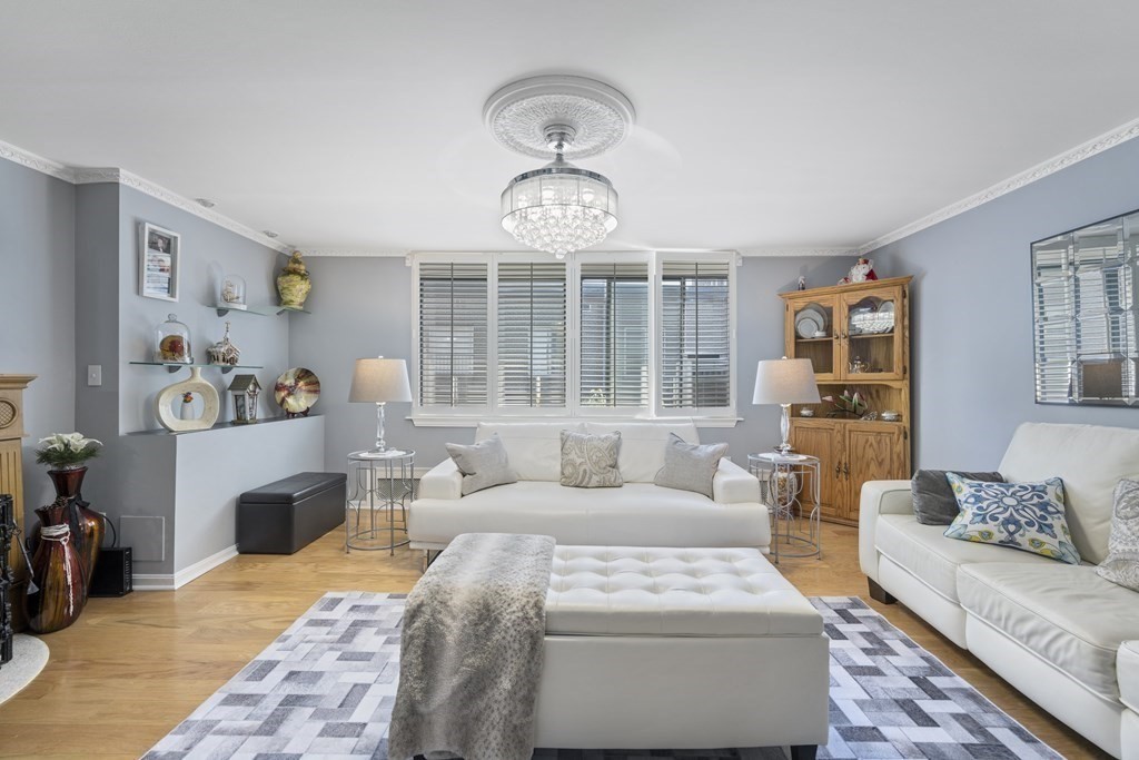 8 Juniper Street, Unit 22 Brookline, MA 02445 - Photo 1 of 11 a living room with furniture and a fireplace