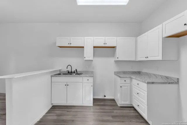 a kitchen with stainless steel appliances granite countertop a sink and cabinets