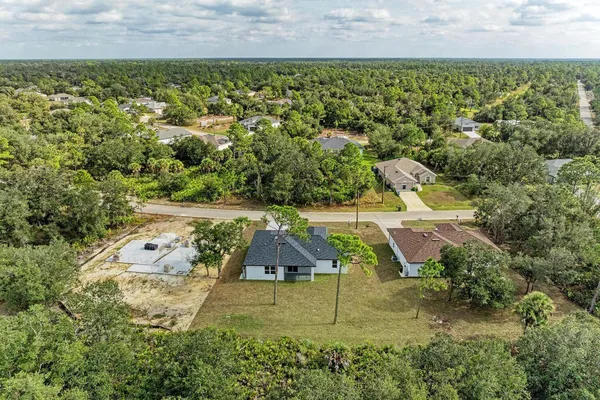 an aerial view of residential houses with outdoor space