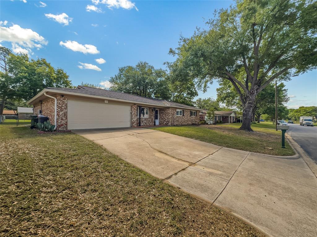 220 Cooper Drive Hurst, TX 76053 - Photo 2 of 27 a house view with a backyard space