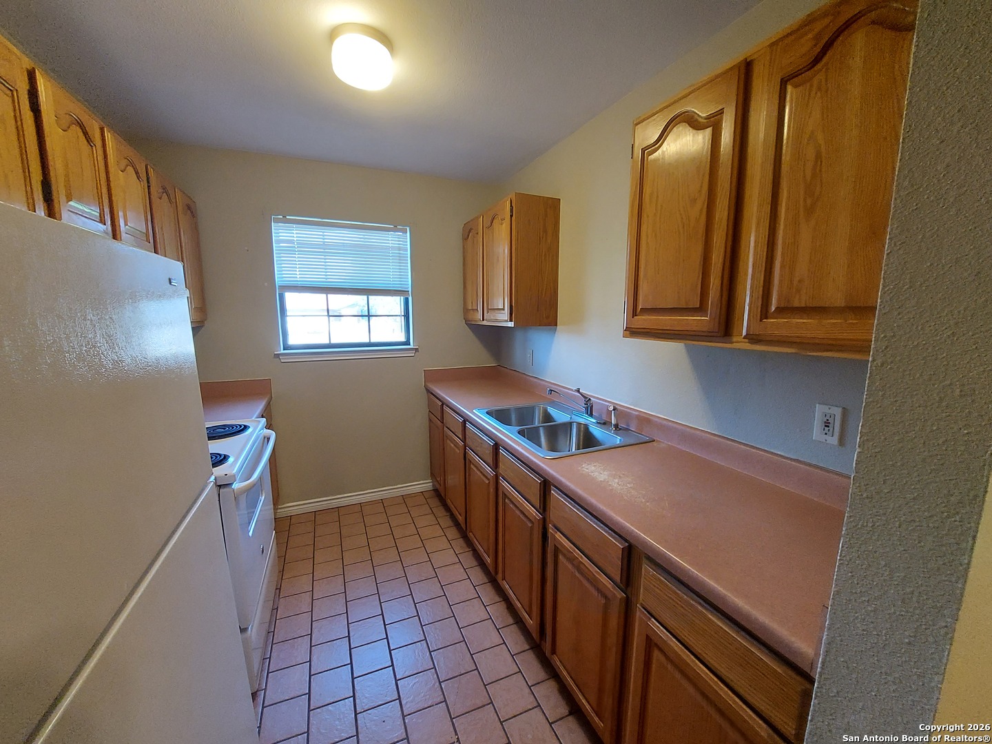 9510 Cross Rdg Lane San Antonio, TX 78263 - Photo 18 of 30 a kitchen with sink cabinets and window