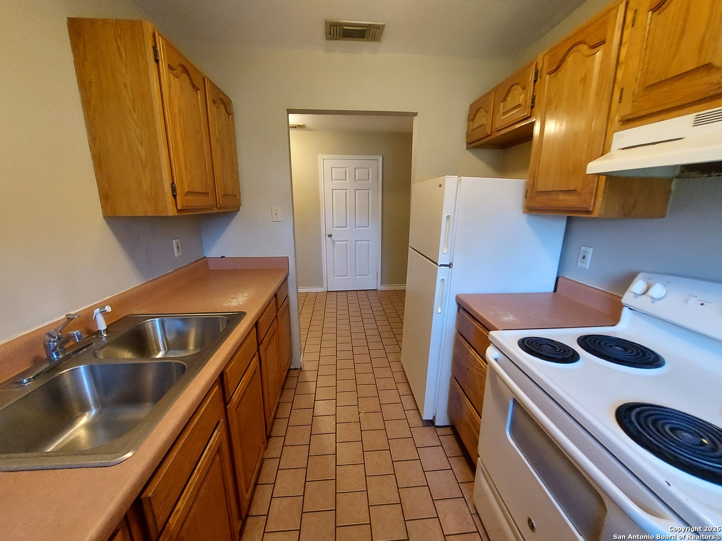 9510 Cross Rdg Lane San Antonio, TX 78263 - Photo 19 of 30 a kitchen that has a sink and a stove