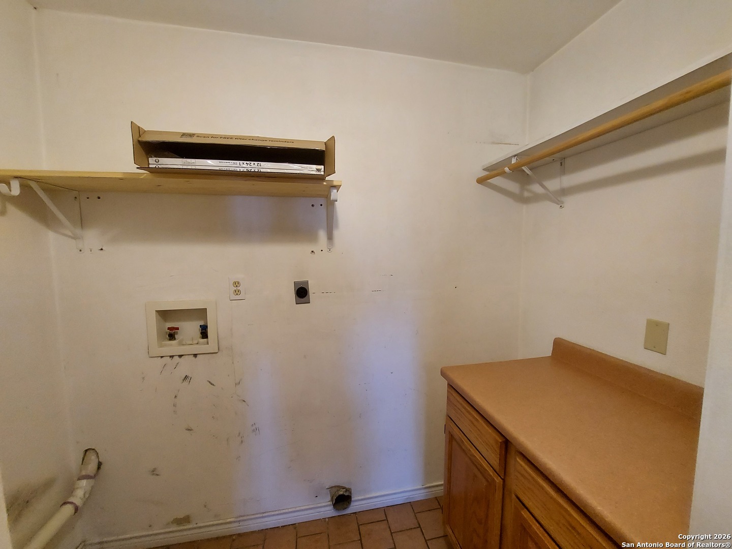 9510 Cross Rdg Lane San Antonio, TX 78263 - Photo 27 of 30 a utility room with a wooden floor and cabinets
