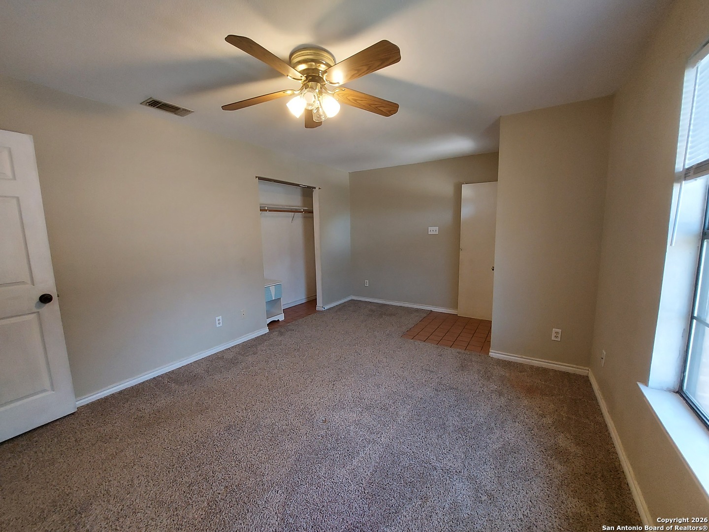 9510 Cross Rdg Lane San Antonio, TX 78263 - Photo 9 of 30 an empty room with windows and fan