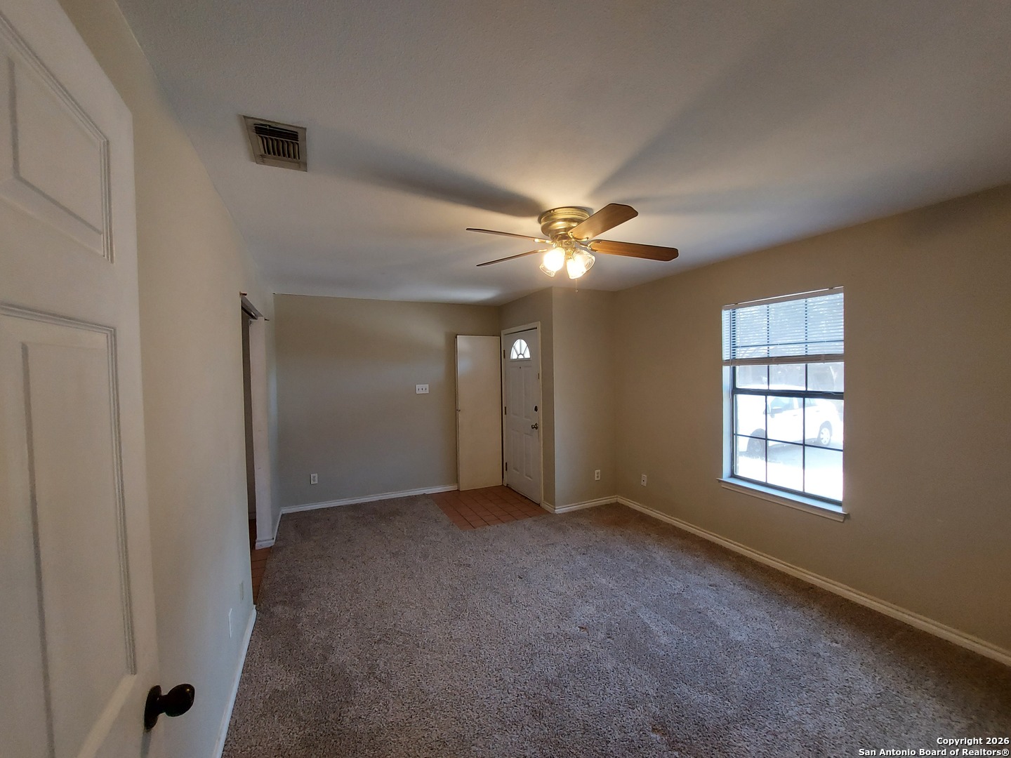 9510 Cross Rdg Lane San Antonio, TX 78263 - Photo 10 of 30 an empty room with chandelier fan and windows