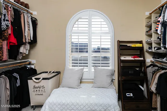 a living room with furniture a flat screen tv and a window