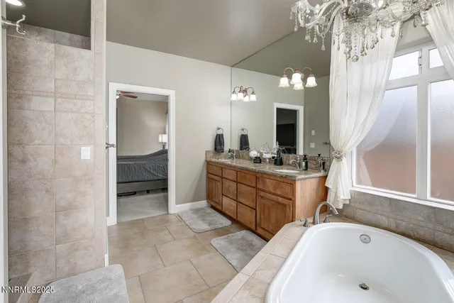 a bathroom with a tub sink and mirror
