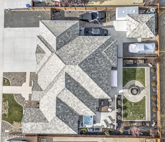 an aerial view of a house with garden space and hanging chair
