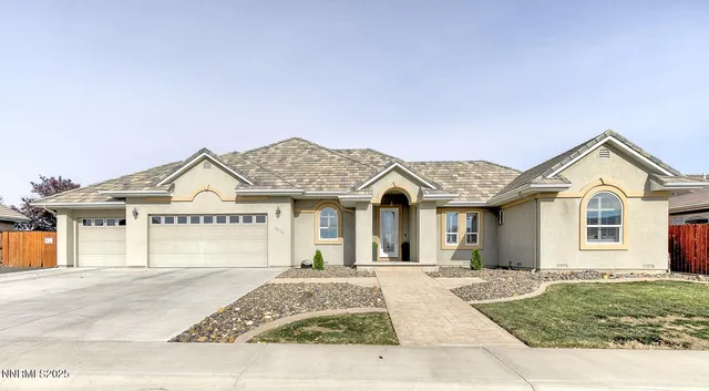 a view of a white house with a yard and plants