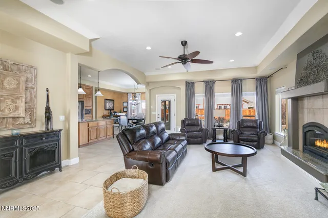 a living room with furniture fireplace and a large window