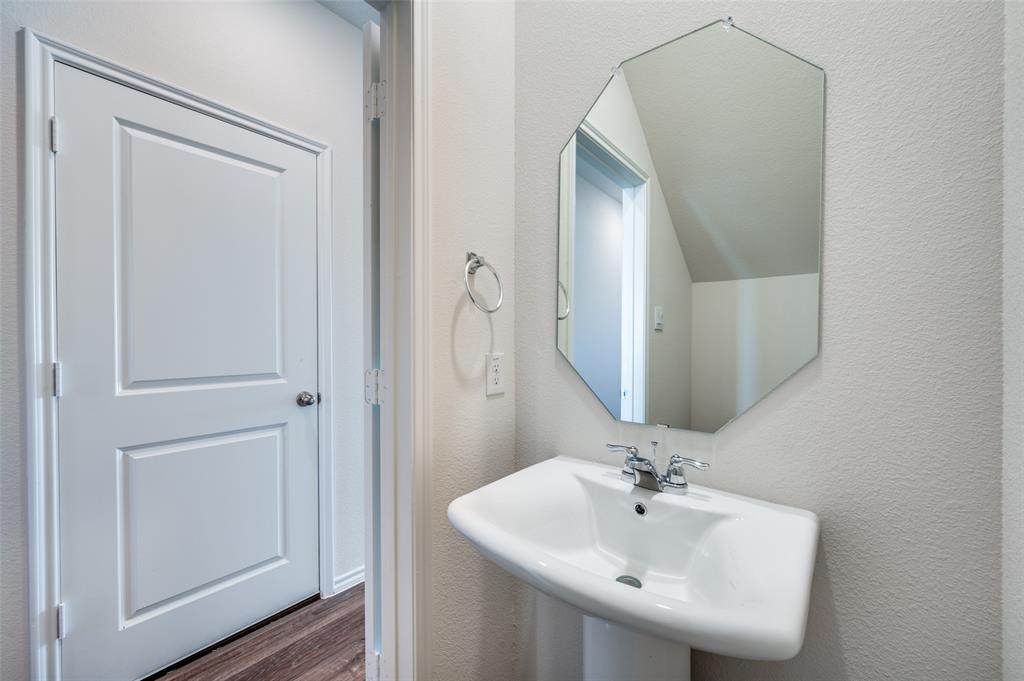 6218 Holly Spg Road Princeton, TX 75407 - Photo 15 of 25 a bathroom with a sink and a mirror