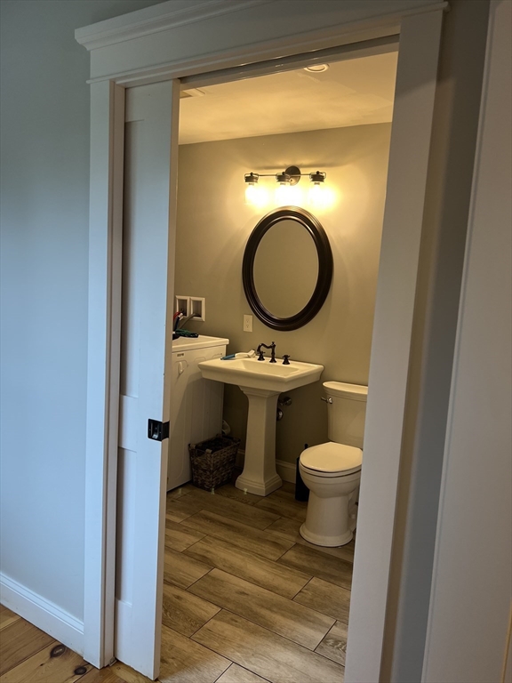 879 Long Pond Road Plymouth, MA 02360 - Photo 16 of 39 a bathroom with a toilet a sink and a mirror