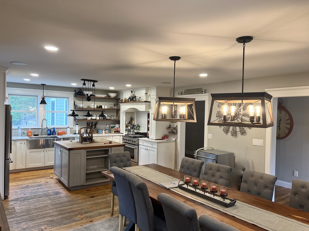 879 Long Pond Road Plymouth, MA 02360 - Photo 17 of 39 a kitchen with refrigerator a stove and a wooden floor
