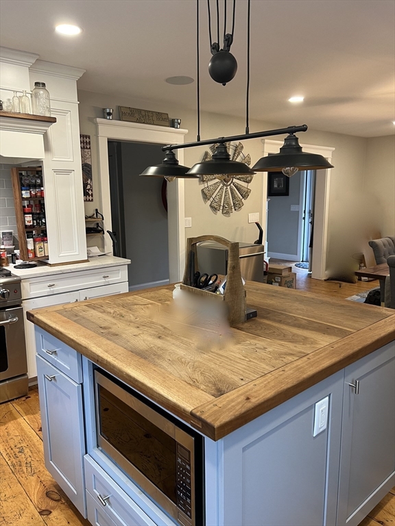 879 Long Pond Road Plymouth, MA 02360 - Photo 21 of 39 a kitchen with a stove and a wooden floor