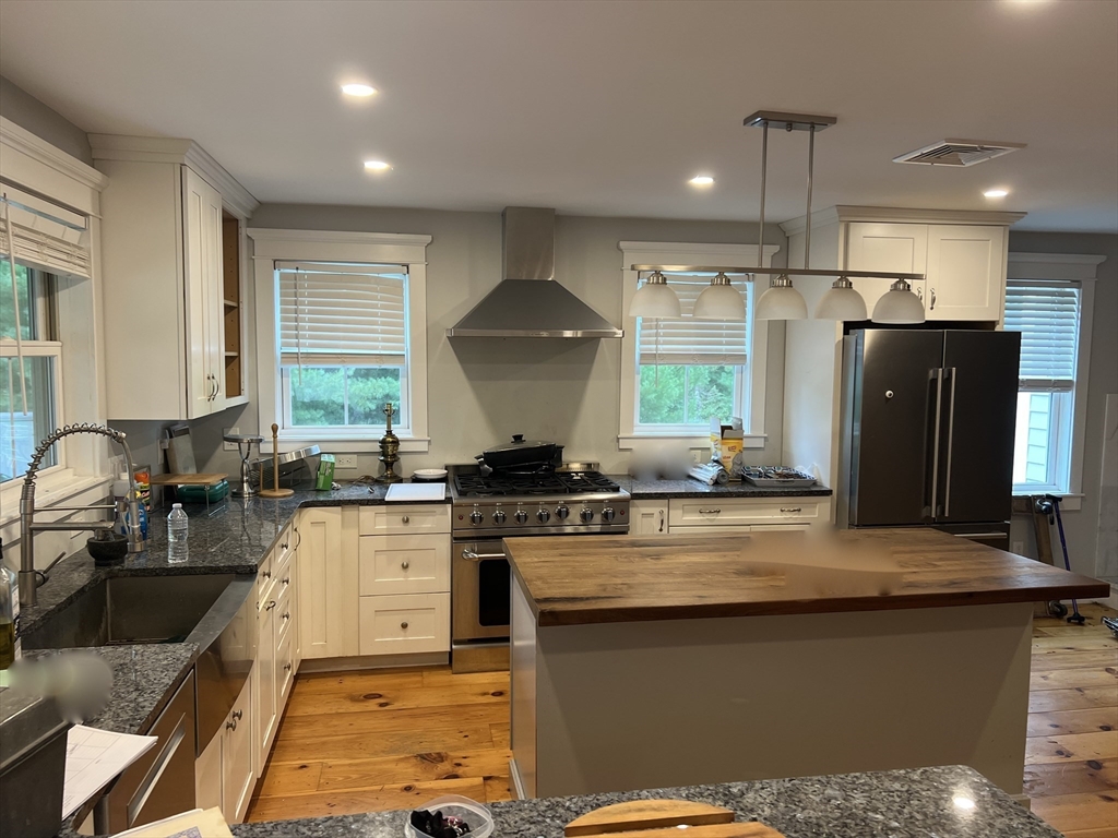 879 Long Pond Road Plymouth, MA 02360 - Photo 23 of 39 a kitchen with stainless steel appliances granite countertop a sink stove and refrigerator