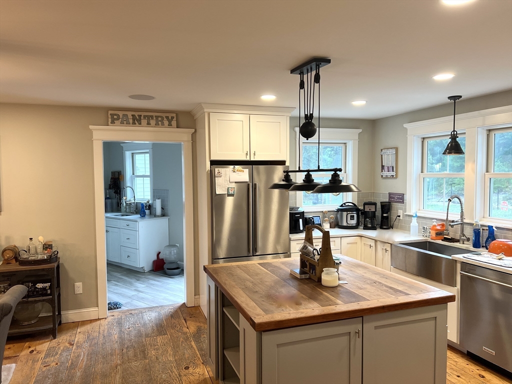 879 Long Pond Road Plymouth, MA 02360 - Photo 3 of 39 a kitchen with stainless steel appliances granite countertop a sink stove and refrigerator