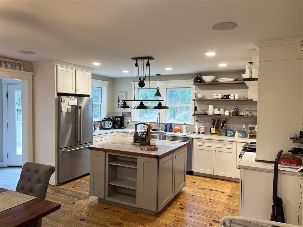 879 Long Pond Road Plymouth, MA 02360 - Photo 4 of 39 a kitchen with stainless steel appliances granite countertop a refrigerator stove top oven and sink