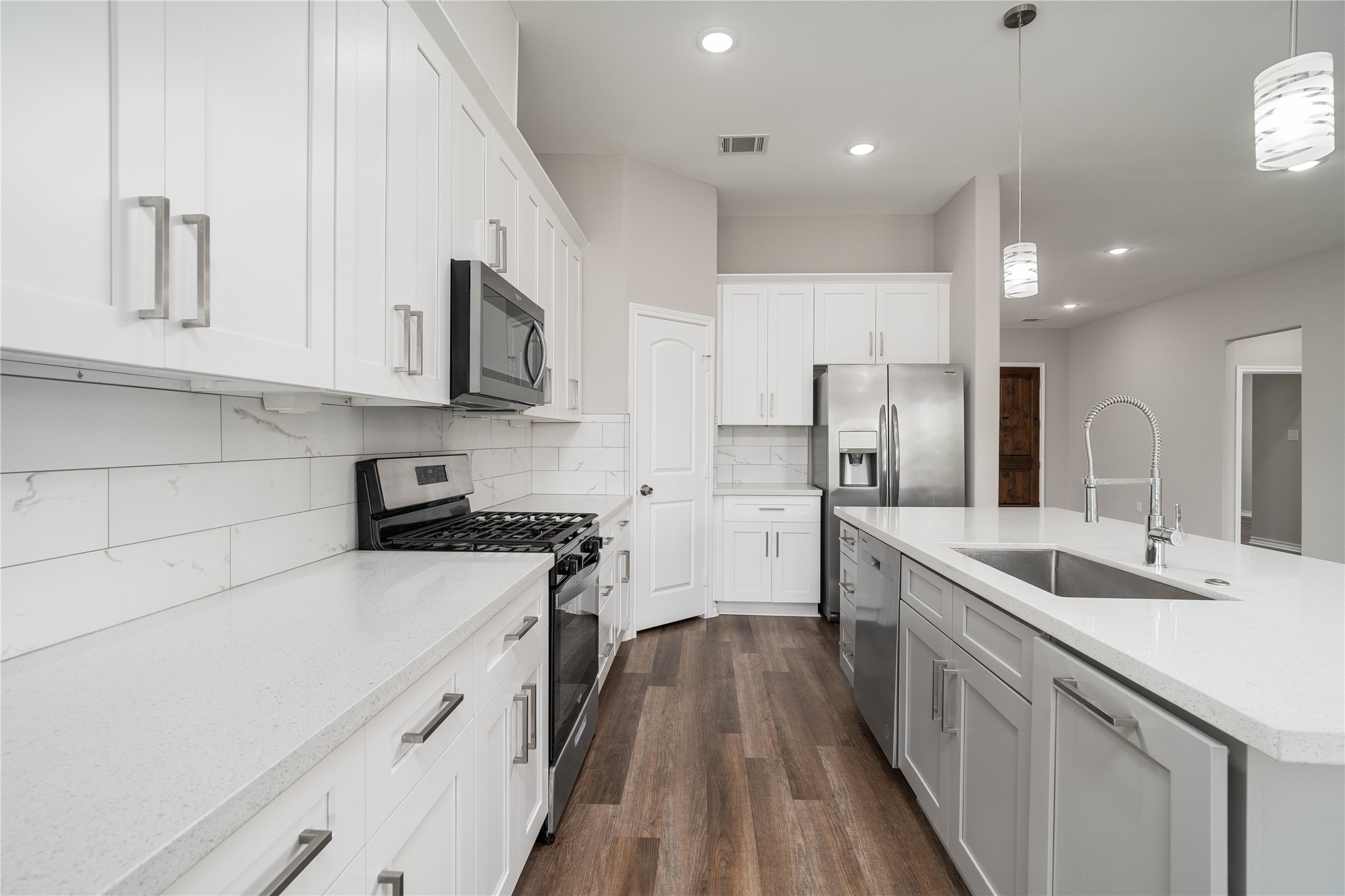 231 McCormick Street Columbus, TX 78934 - Photo 4 of 27 Kitchen – Bright and modern kitchen with stainless steel appliances, abundant cabinetry, and a spacious layout ideal for everyday living and entertaining.