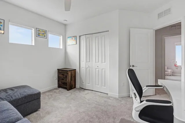a view of a patio with table and chairs potted plants with floor to ceiling window