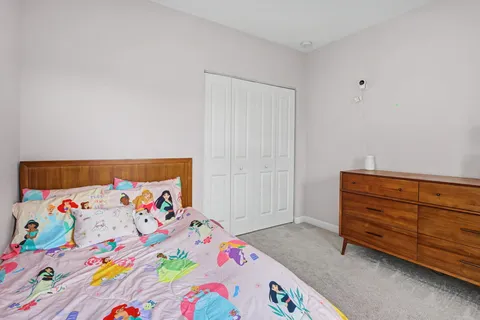 a bedroom with a bed and a dresser