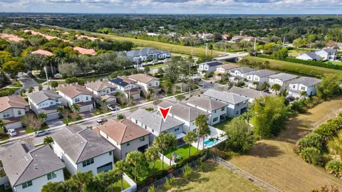 an aerial view of residential houses with outdoor space and swimming pool