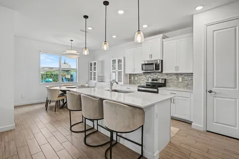 a kitchen with a sink cabinets and window