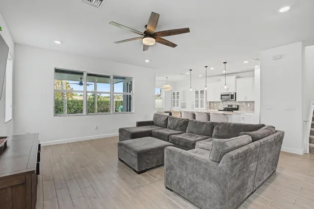 a living room with furniture and a book shelf