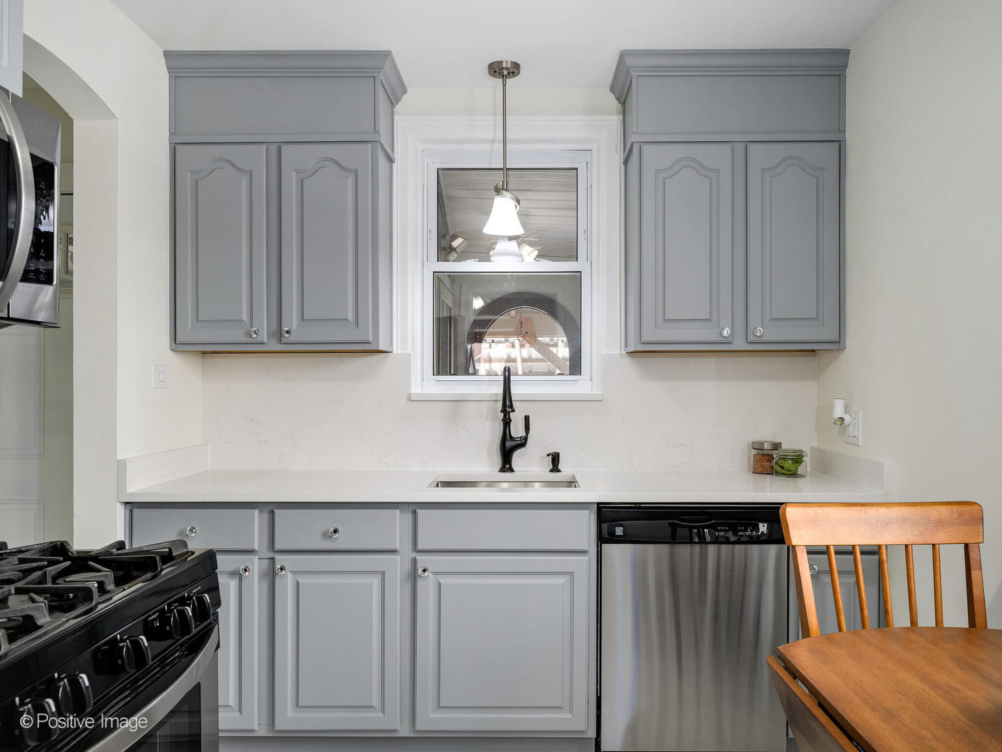 6057 West Melrose Street Chicago, IL 60634 - Photo 14 of 32 a kitchen with stainless steel appliances a stove a sink and cabinets