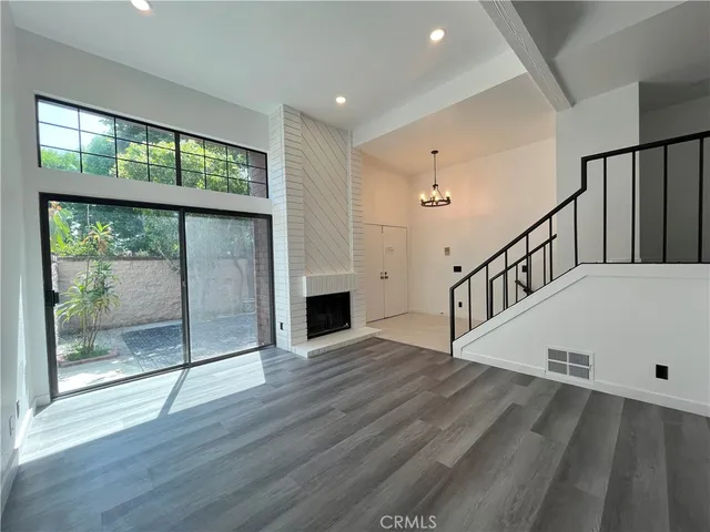a view of front door with hallway and wooden floor